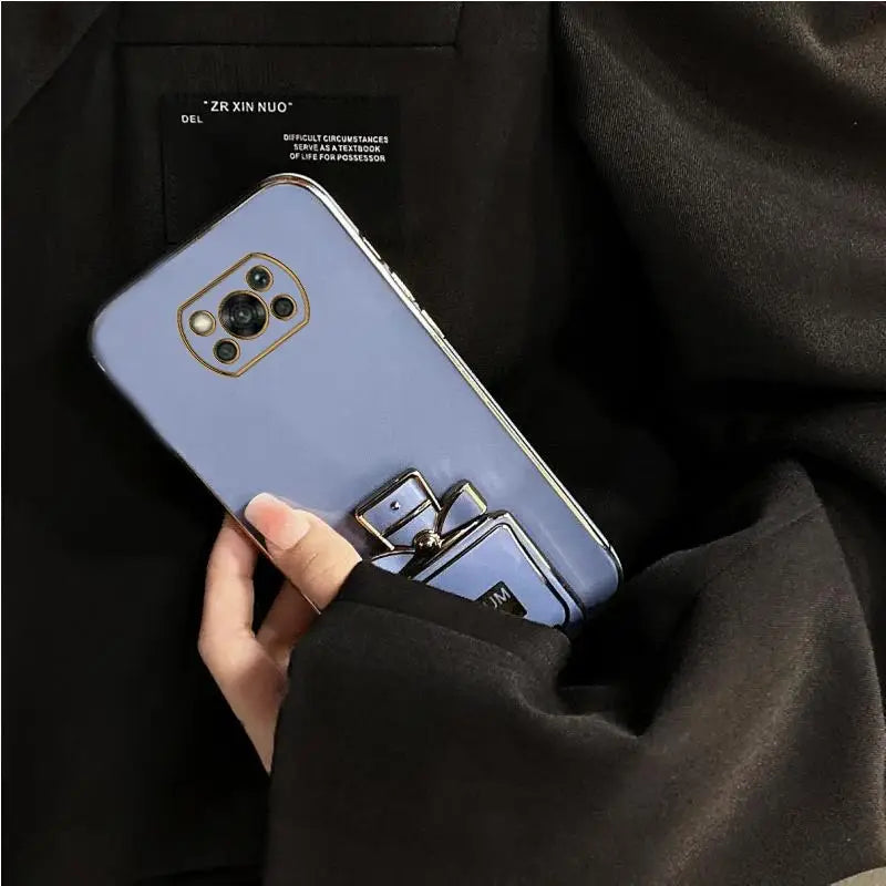 A woman holding a blue phone case