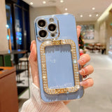 a woman holding a blue phone case with a gold chain