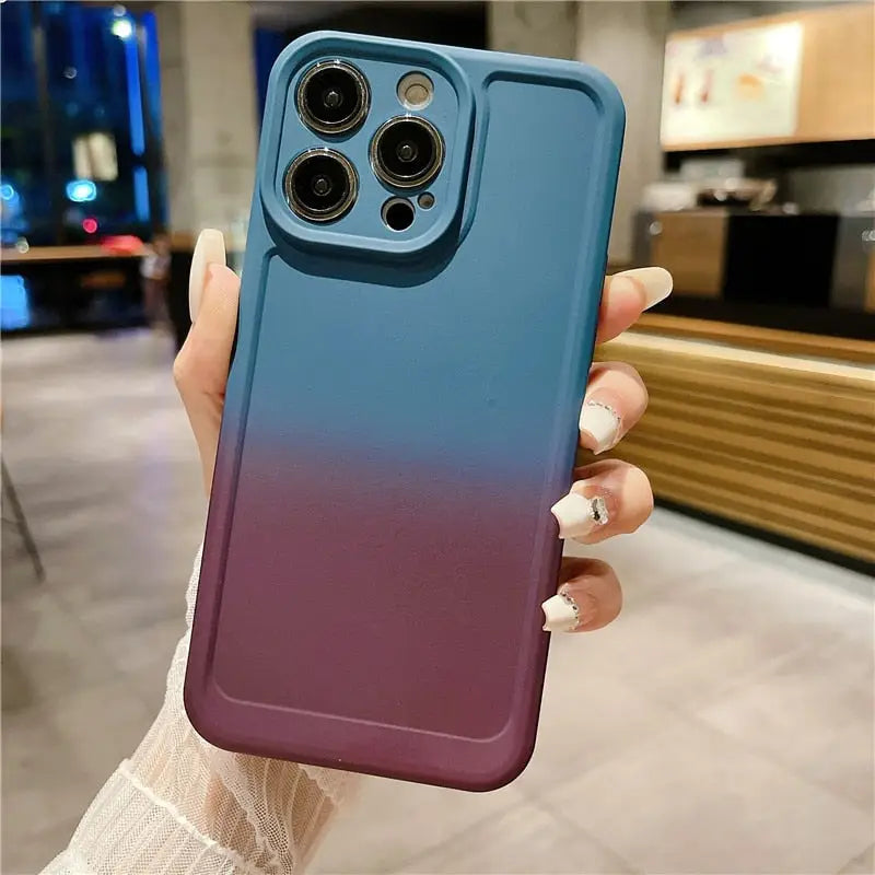 a woman holding up a blue and purple iphone case
