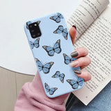 A woman holding a book and a blue butterfly phone case