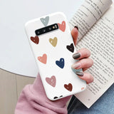 a woman holding a book and holding a phone case