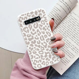 a woman holding a book and a phone case
