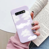 a woman holding a book and a phone case