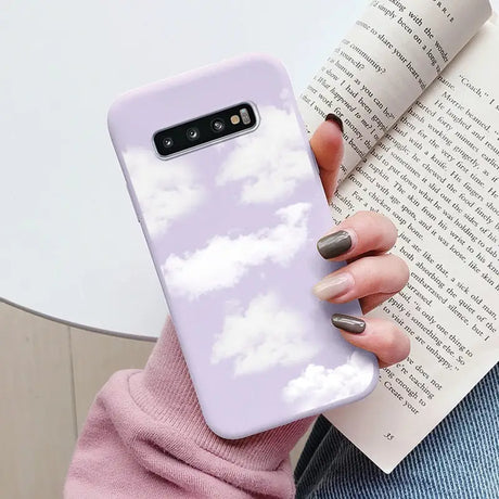 a woman holding a book and a phone case