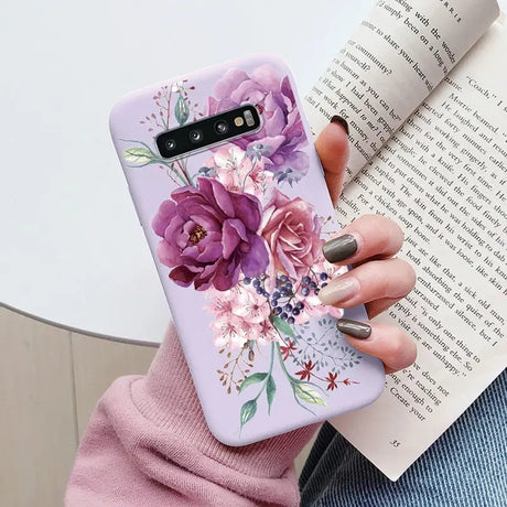 a woman holding a book and a phone case