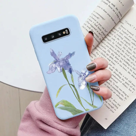 a woman holding a book and a phone case