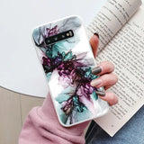 a woman holding a book and a phone case