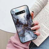 a woman holding a book and a phone case