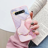 a woman holding a book and holding a phone case