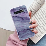 a woman holding a book and a phone case