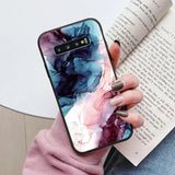 a woman holding a book and a phone case