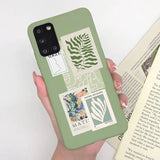 a woman holding a book and a phone case