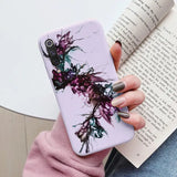 a woman holding a book and a phone case