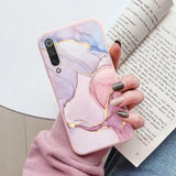 a woman holding a book and a phone case
