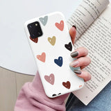 a woman holding a book and holding a phone case