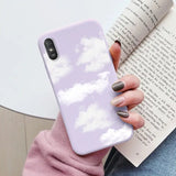 a woman holding a book and a phone case