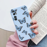 a woman holding a book and a phone case