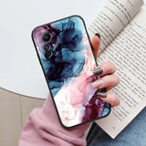 A woman holding a book and holding a phone case
