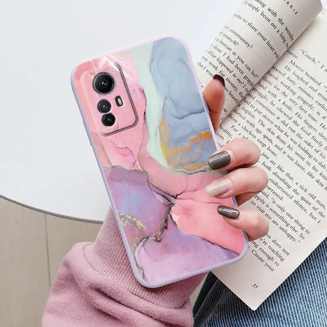 A woman holding a book and holding a phone case