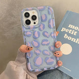 A woman holding a book and a phone case