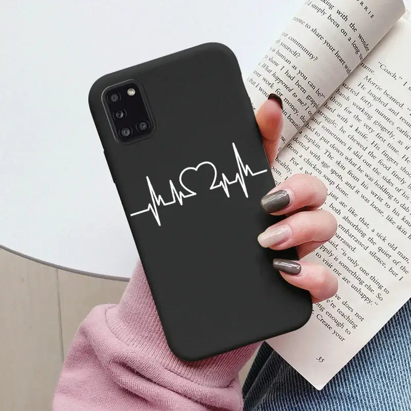 a woman holding a book and a phone case