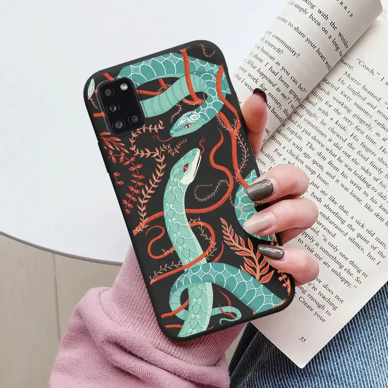 A woman holding a book and a phone case