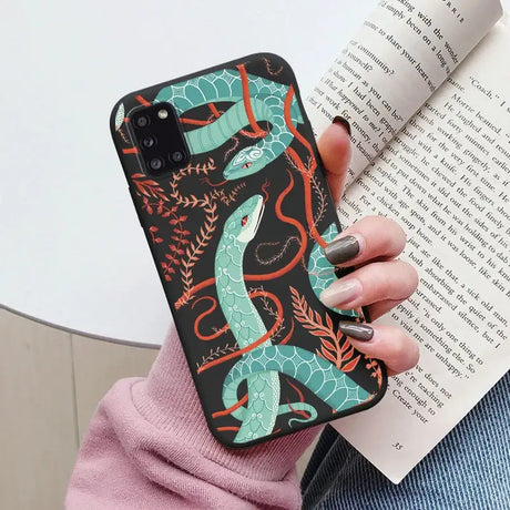 A woman holding a book and a phone case