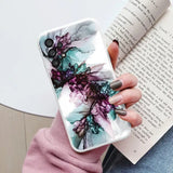 a woman holding a book and a phone case