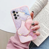 a woman holding a book and holding a phone case