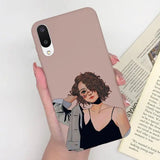 a woman holding a book and a phone case