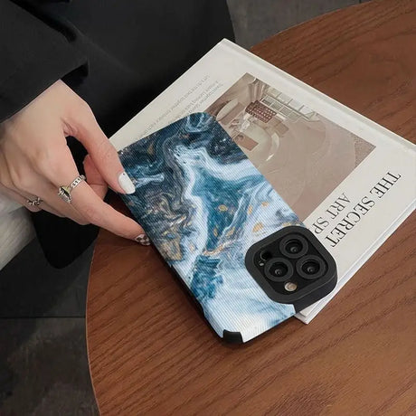 A woman holding a book on a table