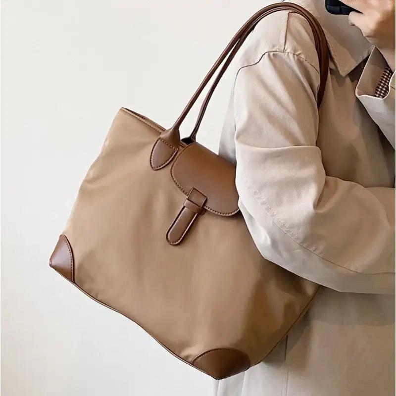 a woman holding a brown bag