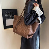 a woman holding a brown bag