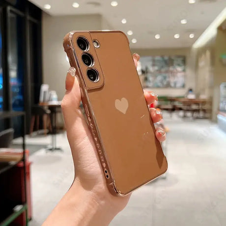 a woman holding up a brown iphone case