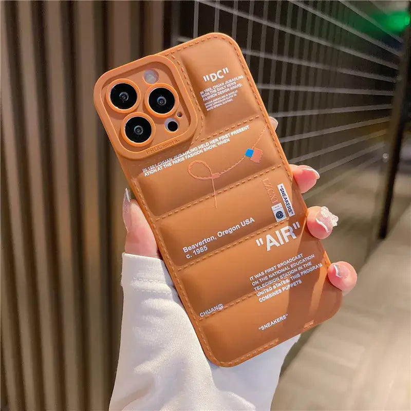 a woman holding a brown iphone case