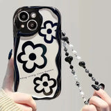 a woman holding a cell case with a black and white design