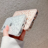 a woman holding a cell case with a pattern on it
