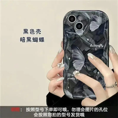 A woman holding a cell phone case with a black marble pattern