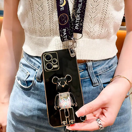 A woman holding a cell phone case with a cat on it