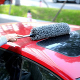 a woman cleaning the windshield of her car