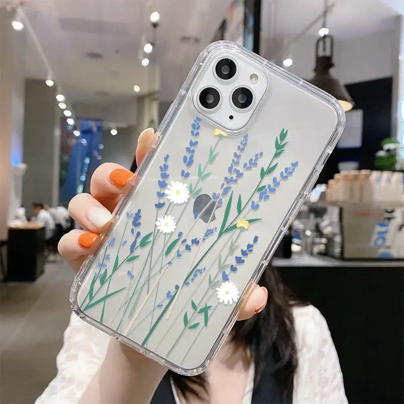 A woman holding up a clear case with flowers on it