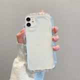 A woman holding a clear case for the iphone