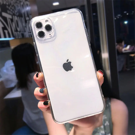 a woman holding up a clear case for an iphone