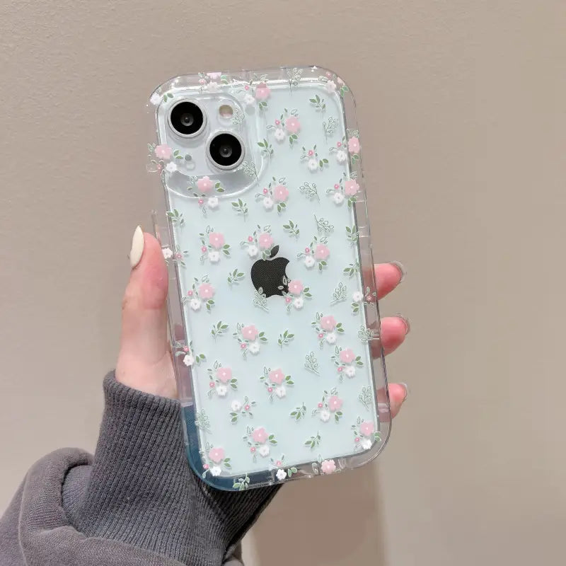 A woman holding a clear case with pink flowers on it