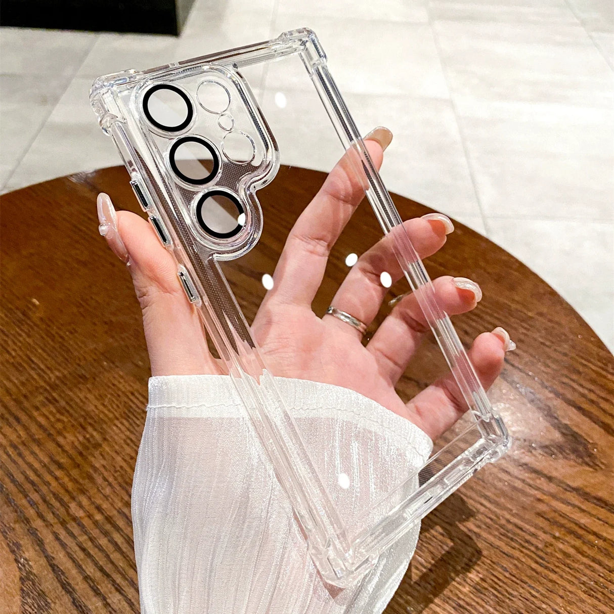 a woman holding a clear case with a ring on it