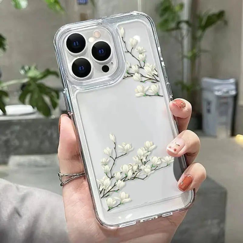 a woman holding a clear case with white flowers on it