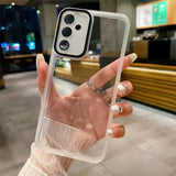 a woman holding up a clear iphone case