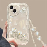 a woman holding a clear phone case with flowers on it