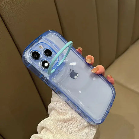 A woman holding a clear phone case with a blue handle