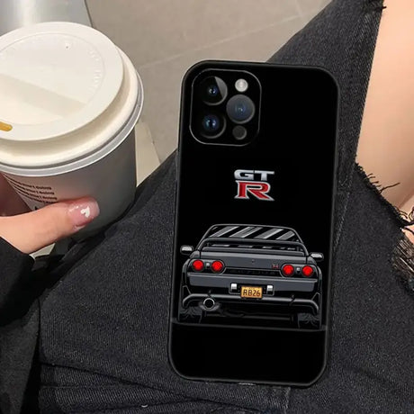 A woman holding a cup and a phone case